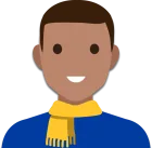 Dark skinned male with short brown hair, a gold scarf and a blue top